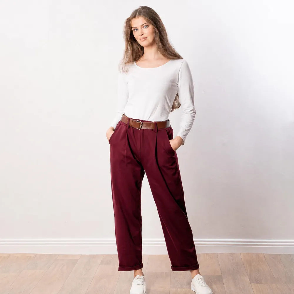 Arya Tapered Trousers in wine — relaxed front view showing tapered leg shape and side seam detail