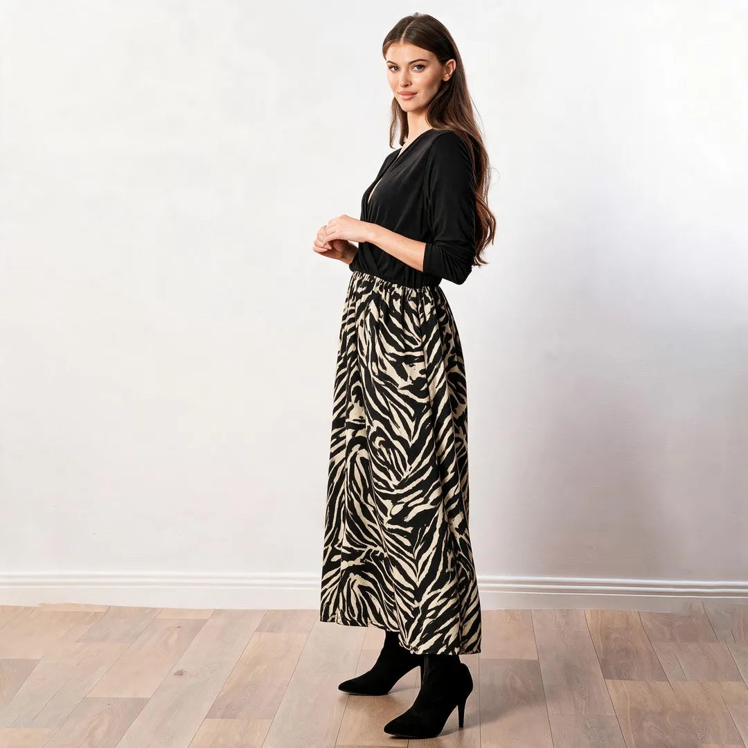 Audrey Dress in black and cream zebra print, side profile showing the drape of the maxi skirt