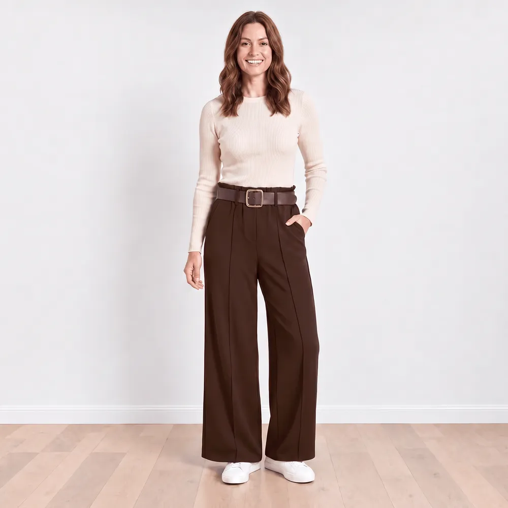 Ellana Trousers in brown — model with hand in side-seam pocket showing wide-leg drape