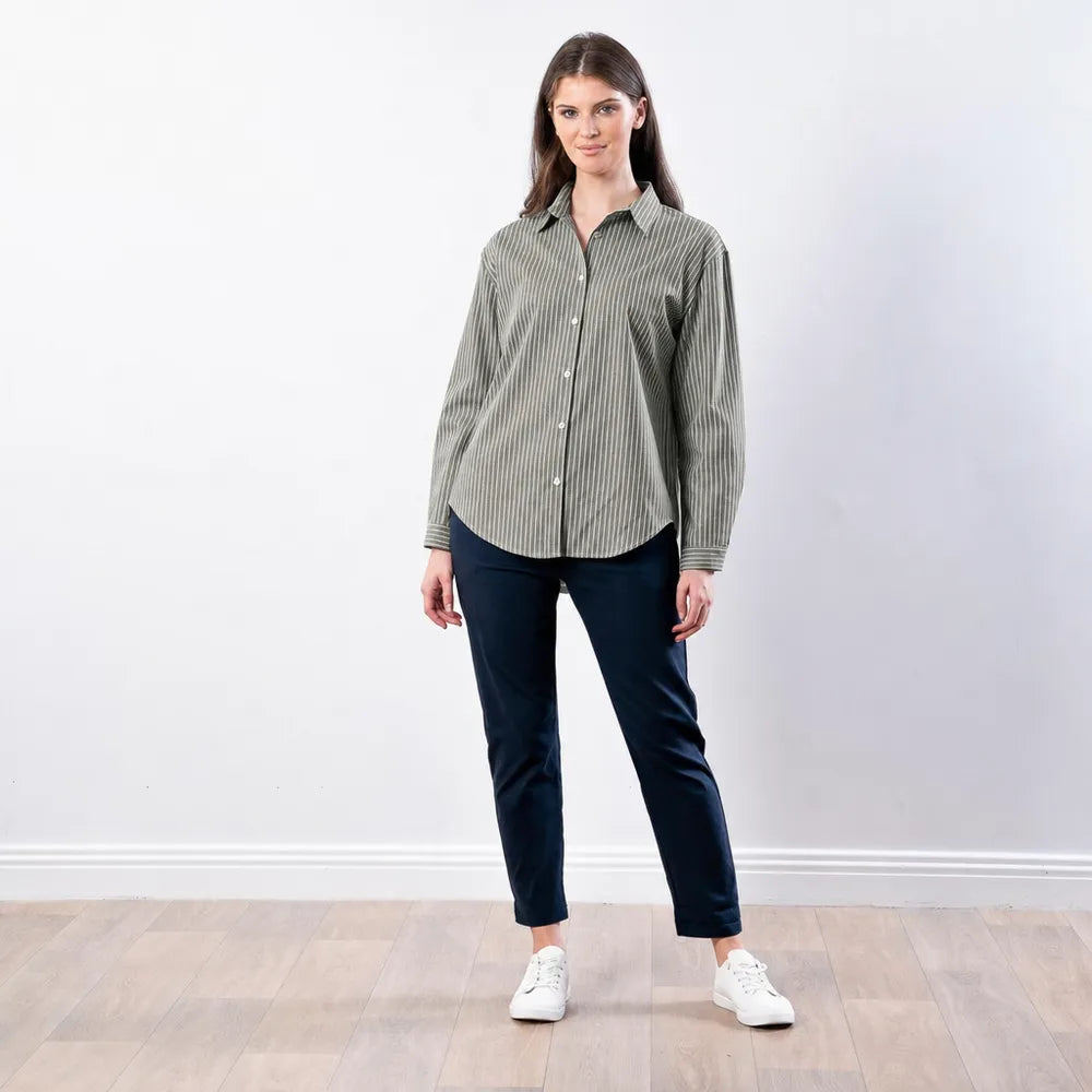 Full length front view of the Fallon Stripe Shirt in green with white pinstripes, worn with navy trousers and white trainers