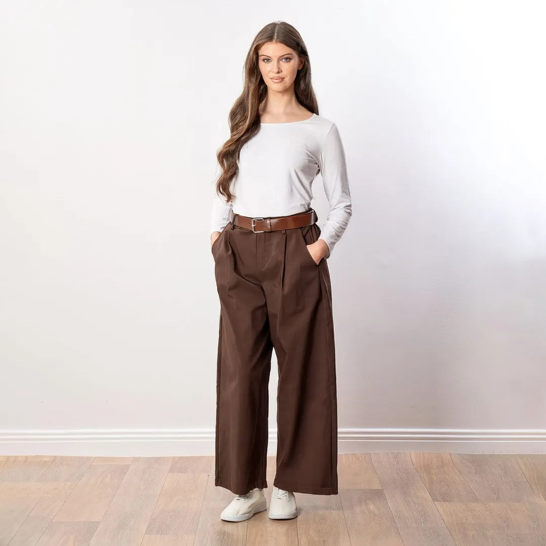 Nora Wide Leg Trousers in brown, front view worn with white long-sleeve top, brown belt and white trainers