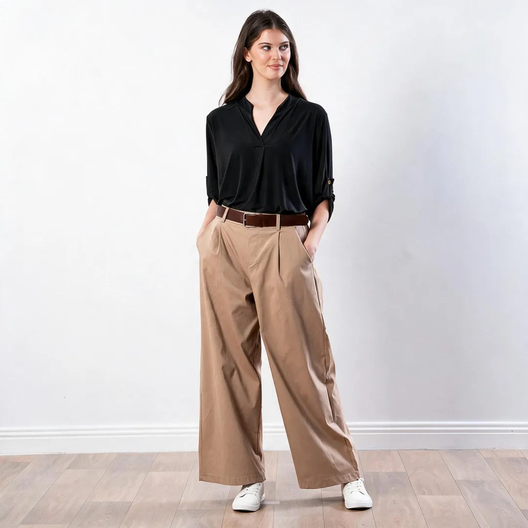 Sharlene Top in black — full-length three-quarter view showing relaxed drape and three-quarter tab-roll sleeves