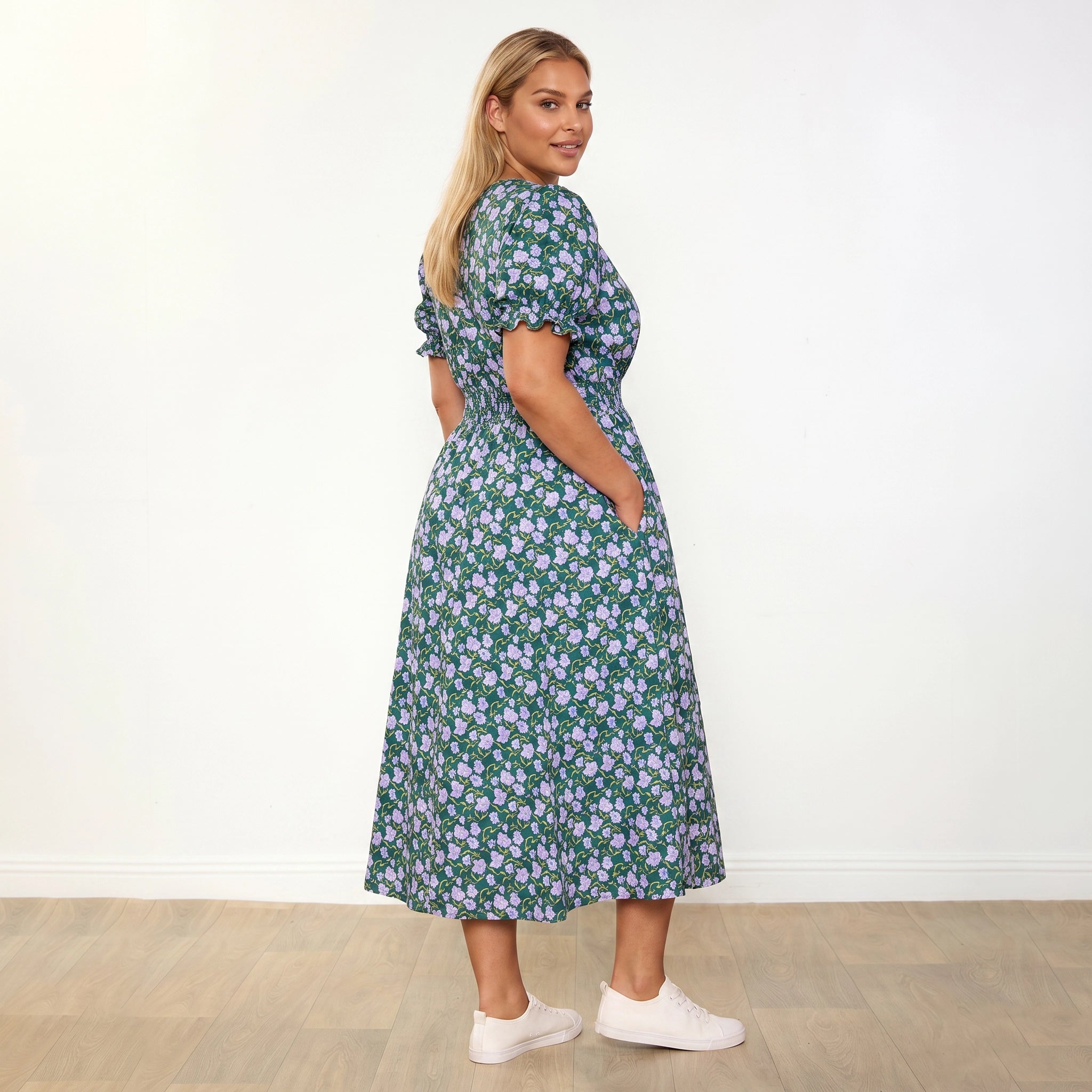 Belle Dress Green Lilac Wildflower - plus size model 3/4 side profile, over-shoulder smile