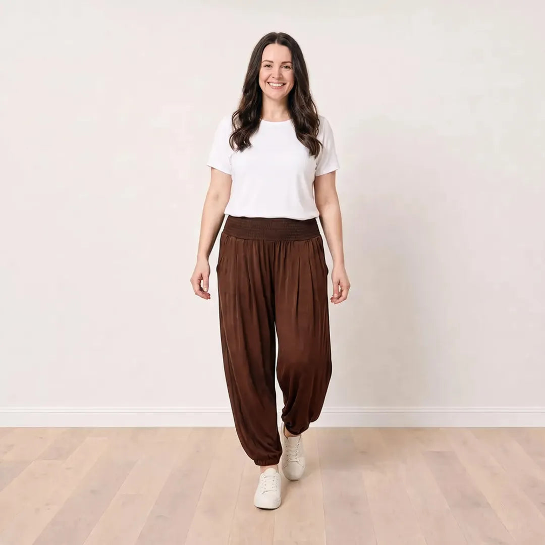 T_Róisín walking in Orla Trousers in Chocolate Brown