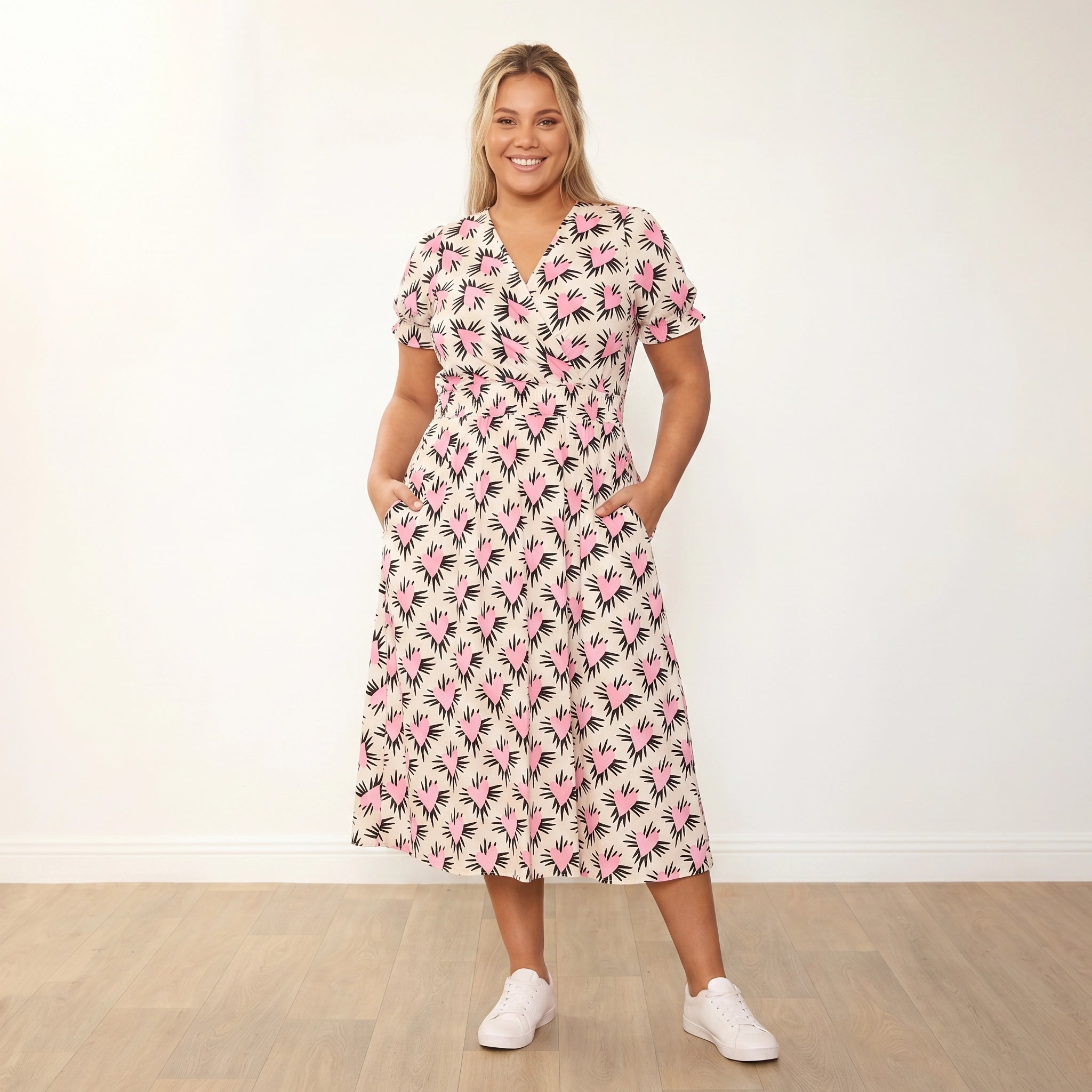 Belle Dress (Pink Heart) - Plus Size Model XXL, hands in pockets candid warm smile