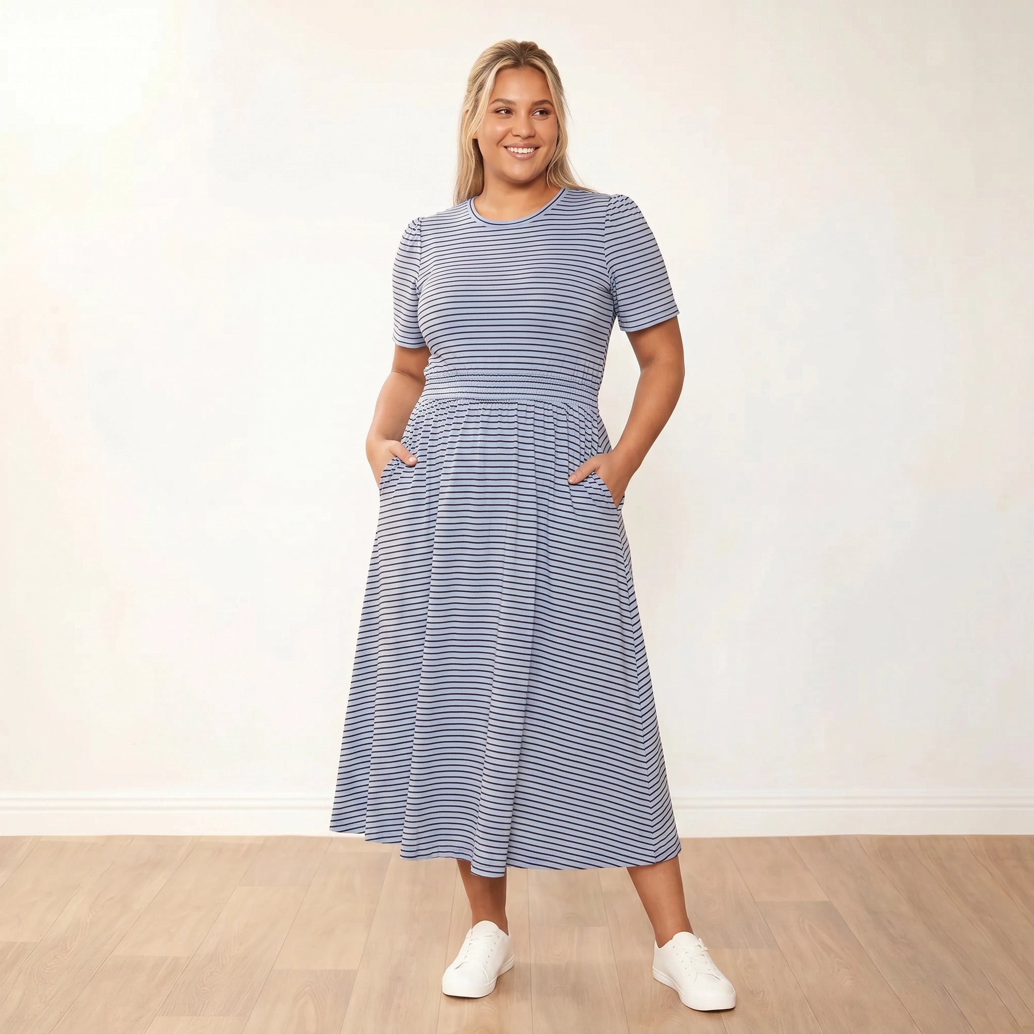 Eilish Dress (Blue/Brown) - Front, warm smile, hands in pockets - Plus Size