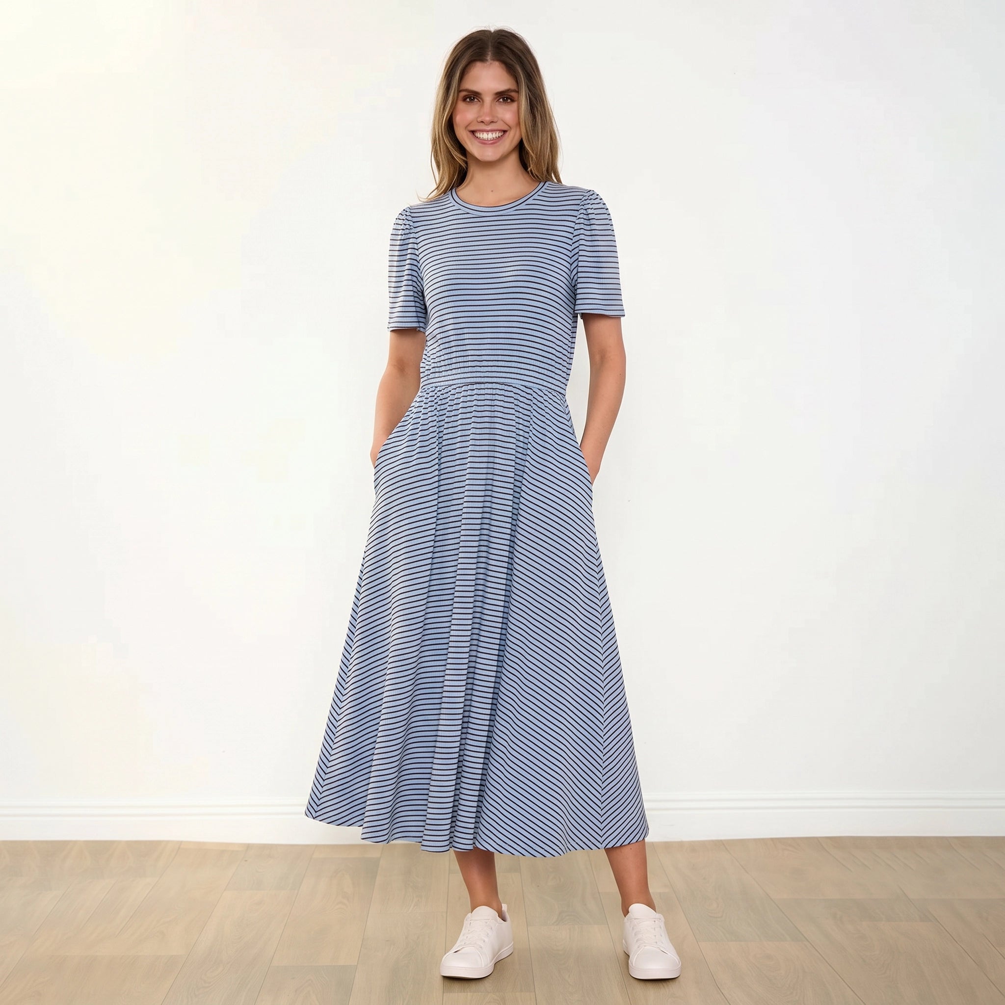 Eilish Dress (Blue/Brown) - Front, smiling, hands in pockets