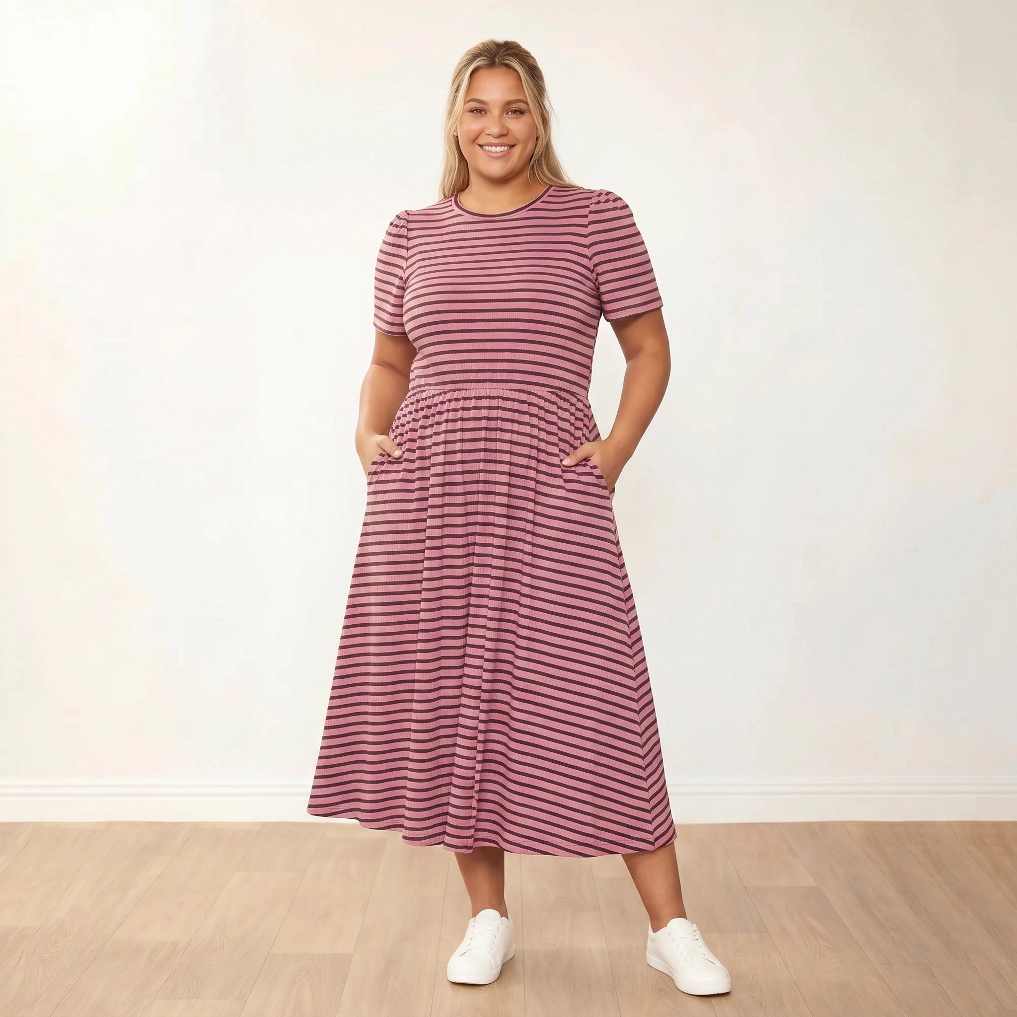 Eilish Dress (Pink/Brown) - Plus Size XXL - Front, hands in pockets, warm smile