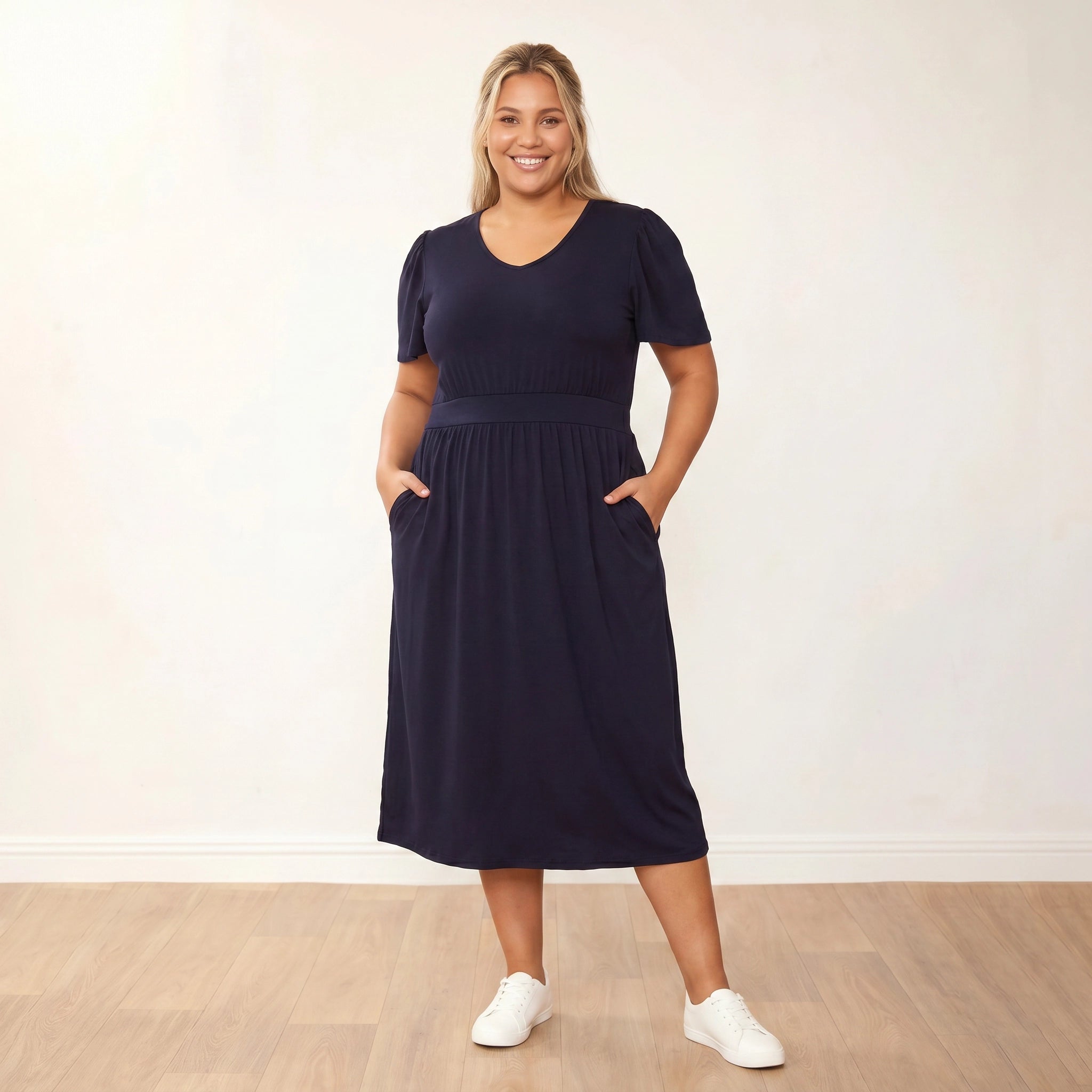 Lois Dress (Black) - Plus Size XXL - Front, hands in pockets, warm smile
