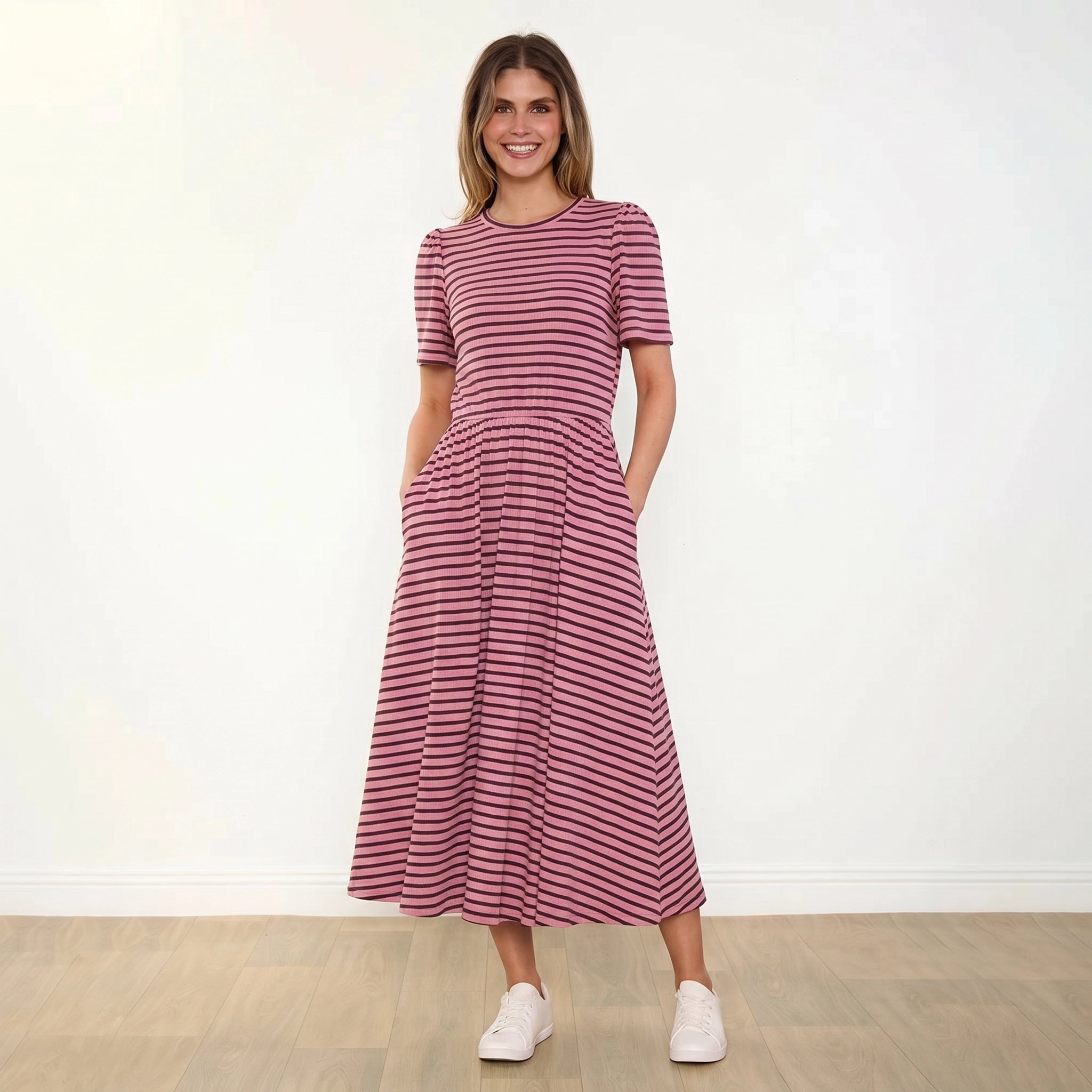 Eilish Dress (Pink/Brown) - Front, hands in pockets, smiling
