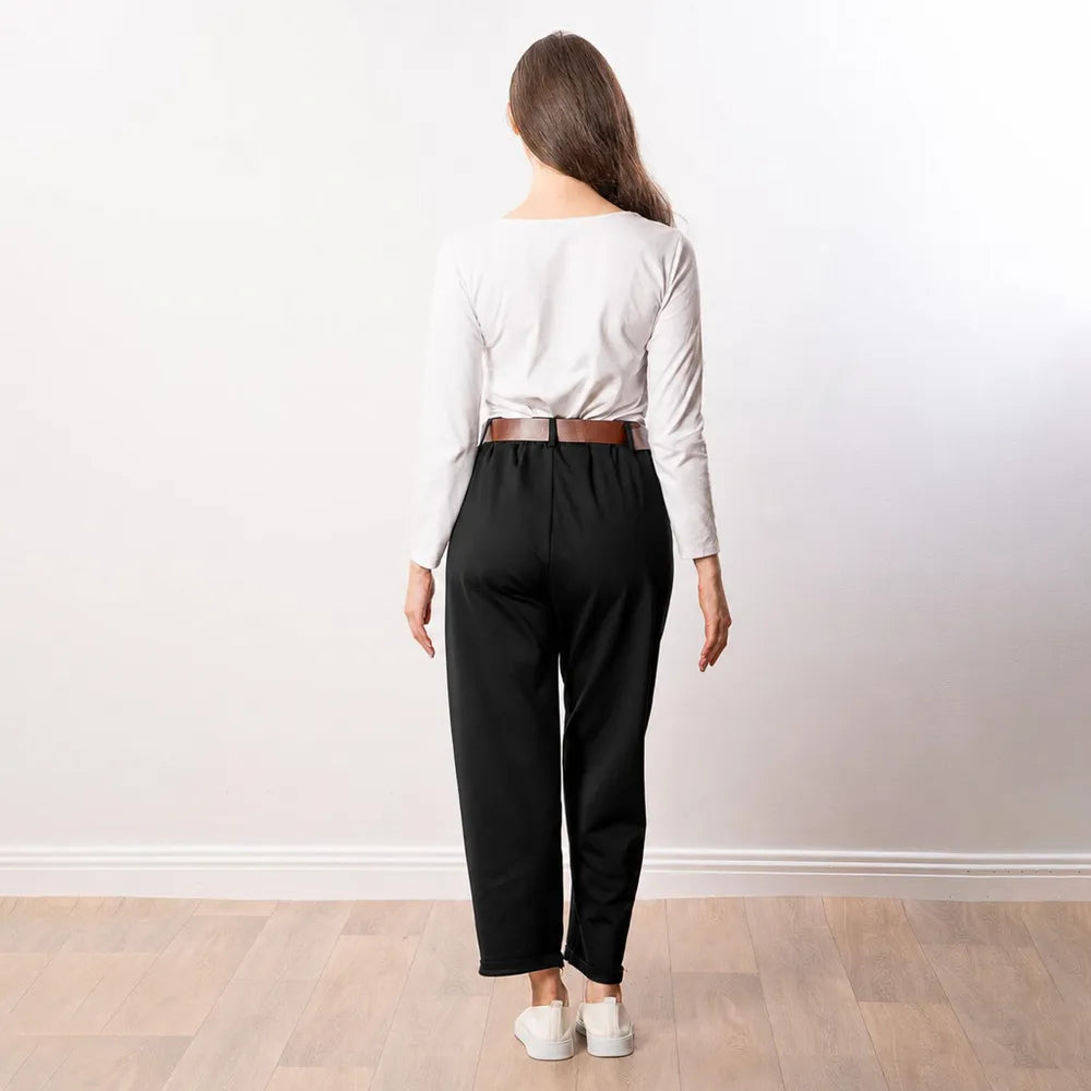 Back view of black Arya tapered trousers showing elasticated waistband, tapered leg and turned-up hem