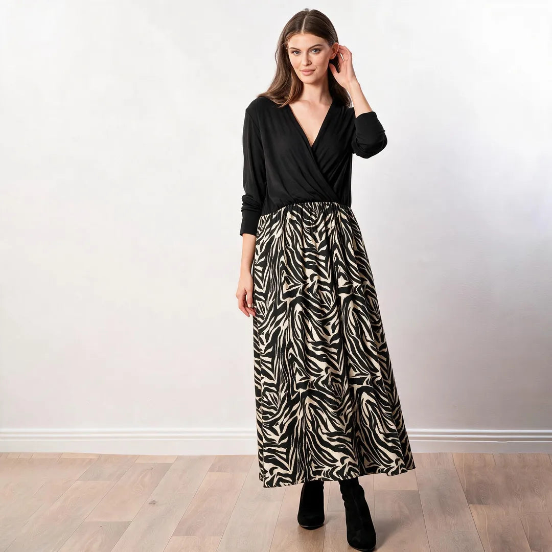 Audrey Dress in black and cream zebra print, front three-quarter view with hand at hair