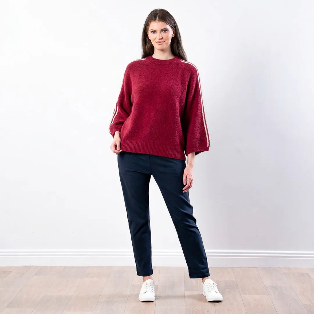 Debbie Knit Jumper Stripe in wine, front view worn with navy tapered trousers and white trainers