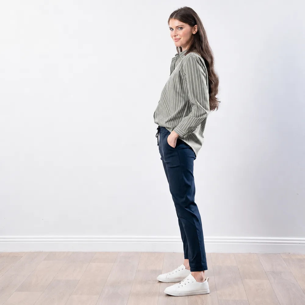 Side profile of the Fallon Stripe Shirt in green with white pinstripes, showing the sleeve length and hem drape