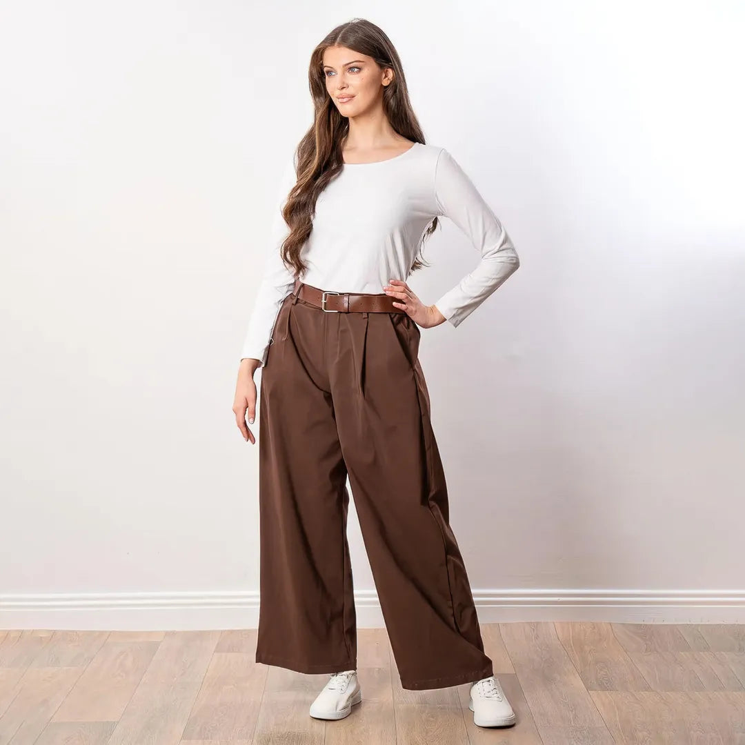 Nora Wide Leg Trousers in brown, three-quarter view with hand on hip