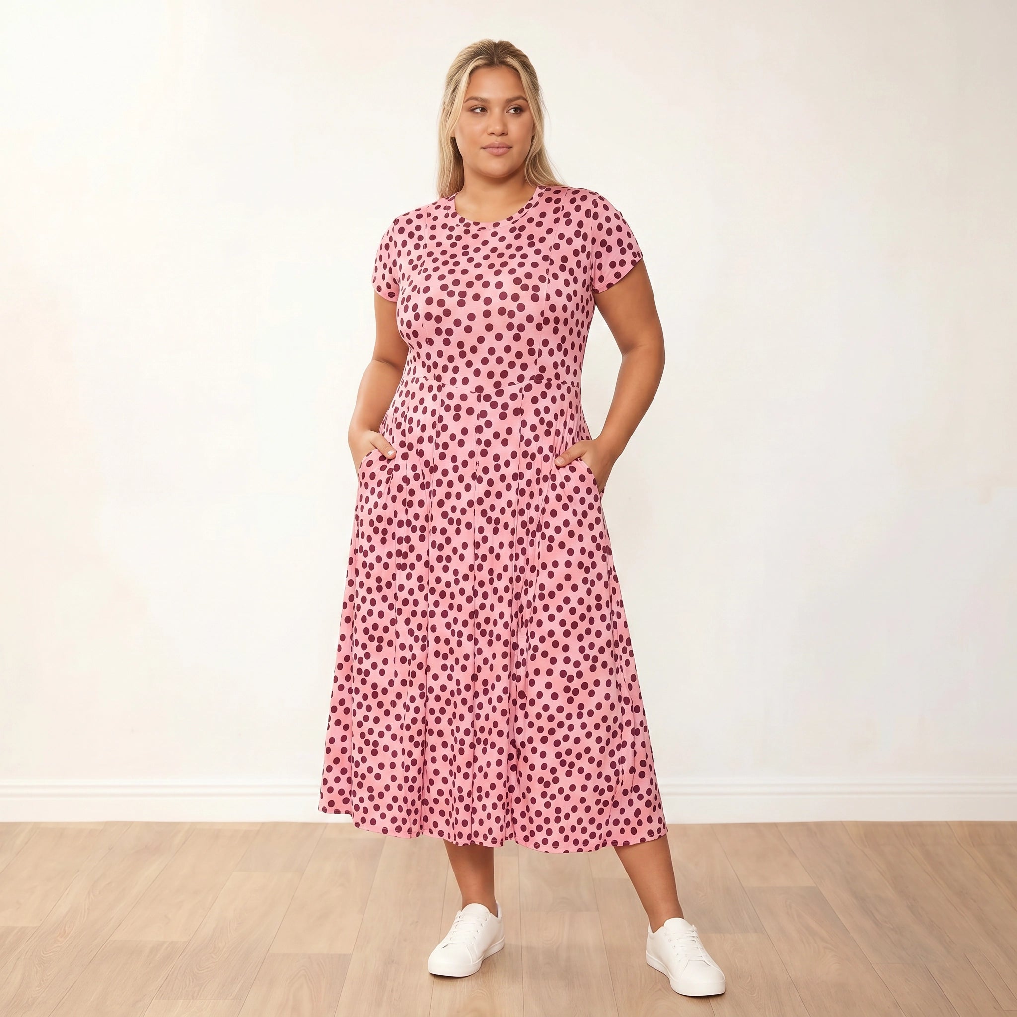 Polly Dress (Polka Dot) - Plus Size XXL - Front, gaze off-camera, hands in pockets