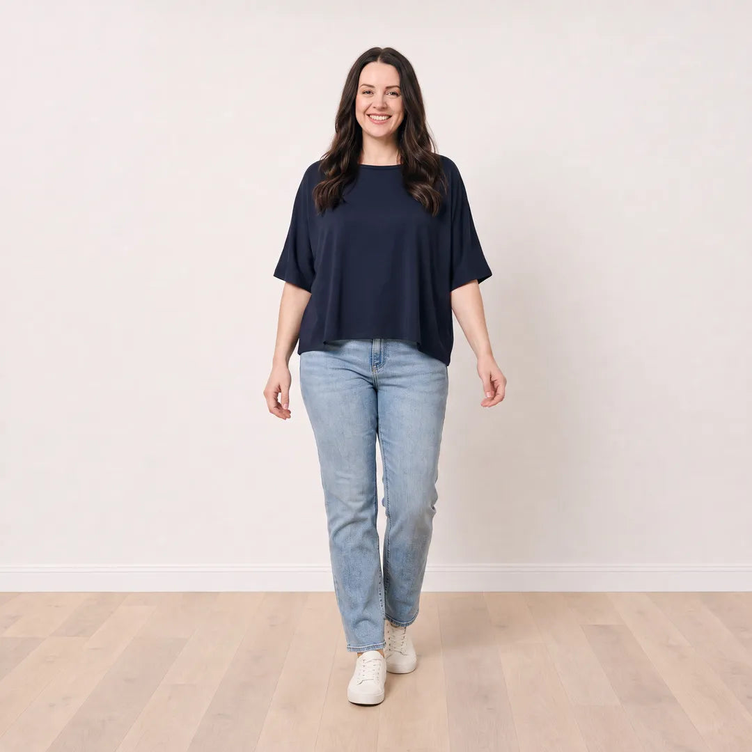 Orla Top in navy styled with light-wash straight-leg jeans — walking view