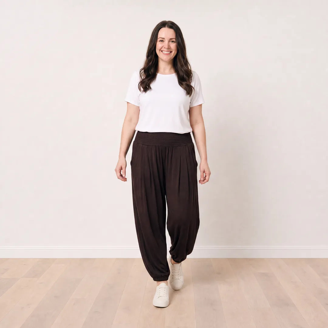 T_Róisín walking in Orla Trousers in Chocolate Brown