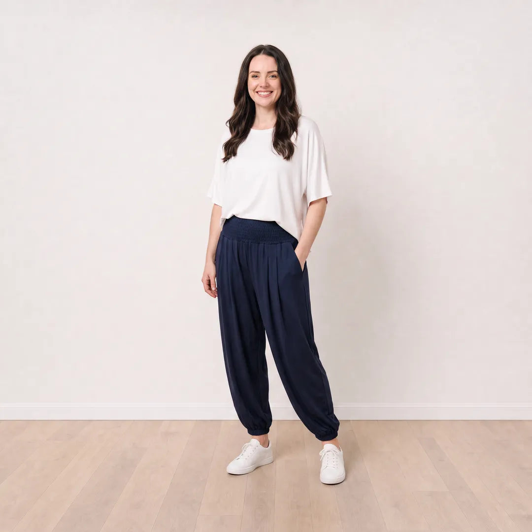 Orla Trousers in navy on T_Róisín, front pocket pose with white top